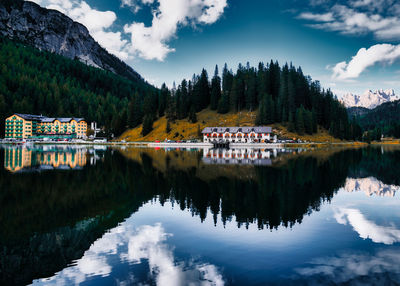 Scenic view of lake by trees against sky