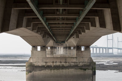 Below view of bridge over sea against sky