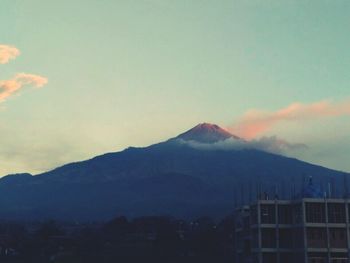 Scenic view of mountains against sky at sunset