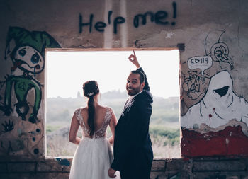 Friends standing on wall