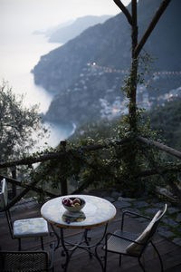 Fruit bowl on table at resort patio with mountains in background