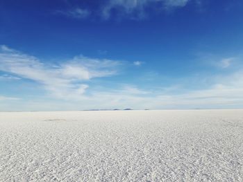 Scenic view of salar de uyuni against blue sky