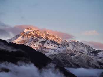 Scenic view of snowcapped mountains against sky during sunset