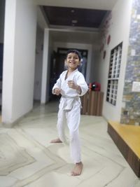 Portrait of smiling girl standing on floor in building