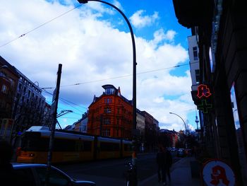 Low angle view of buildings against cloudy sky