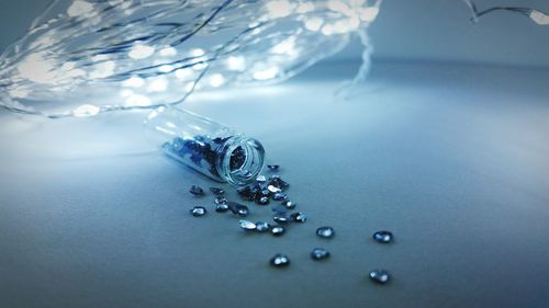 Close-up of gemstones with illuminated string lights on table