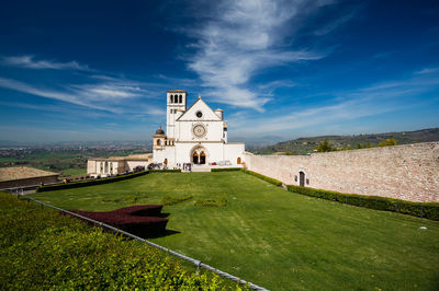 Church by building against sky