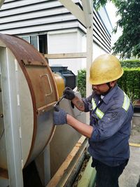 Man repairing machinery with spanner