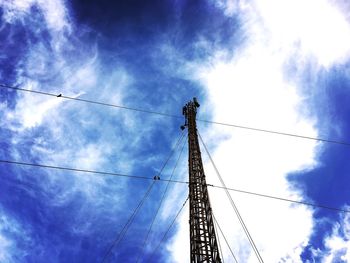 Low angle view of crane against blue sky