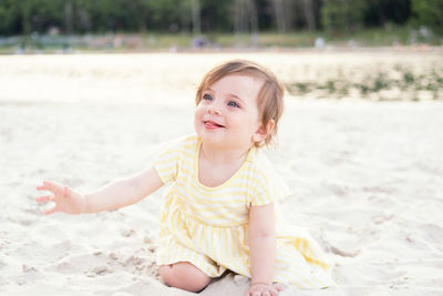 Portrait of cute girl playing at beach
