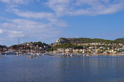 View of town by sea against sky