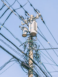 Low angle view of electric lamp against sky