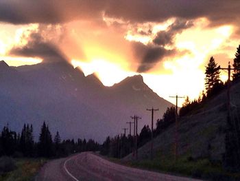 Scenic view of silhouette mountains against sky during sunset