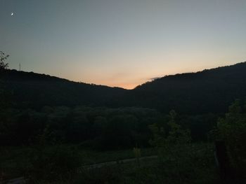 Scenic view of mountains against sky at sunset