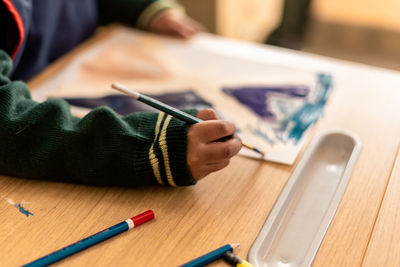 Close up shot of kids doing painting