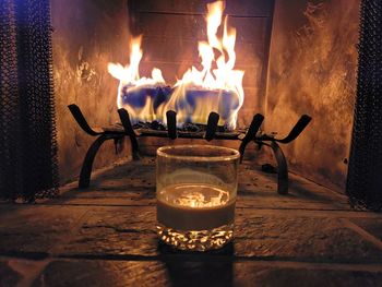 Burning candles on wooden table