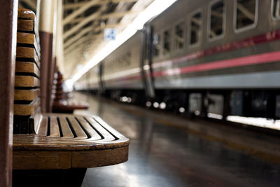 Empty wooden seat at railroad station platform