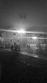 Woman in illuminated city at night