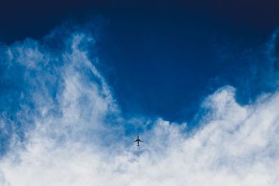 Low angle view of airplane flying in sky