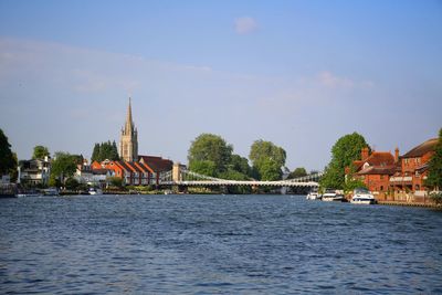 River amidst buildings against sky