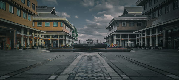 Street amidst buildings against sky