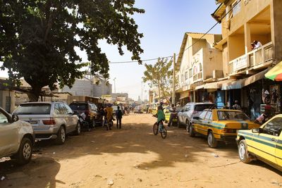 Cars on city street by buildings