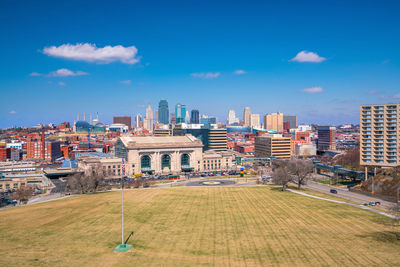 Buildings in city against blue sky