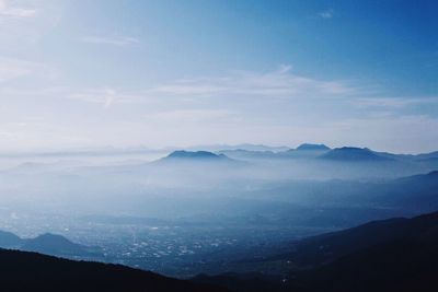 Scenic view of snowcapped mountains against cloudy sky