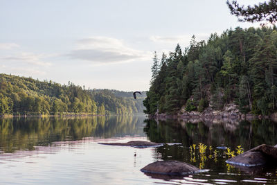 Scenic view of lake against cloudy sky