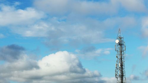 Low angle view of communications tower against sky