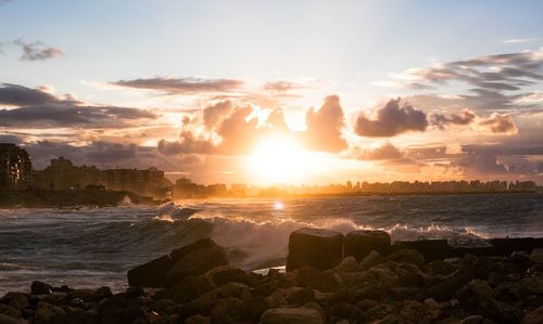 Scenic view of beach against sky during sunset