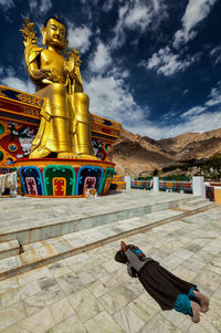 Statue of buddha against building