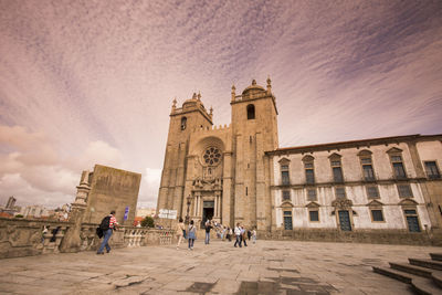 People outside porto cathedral during sunset in city
