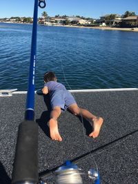 Rear view of boy on water