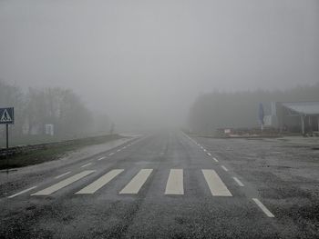 Road by fog against sky