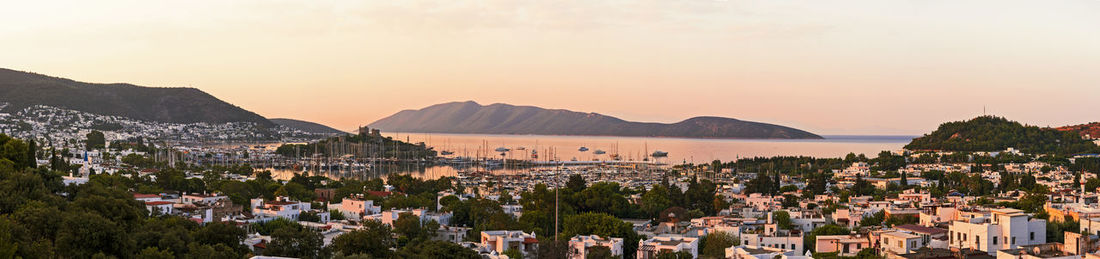 Panoramic shot of townscape against sky during sunset