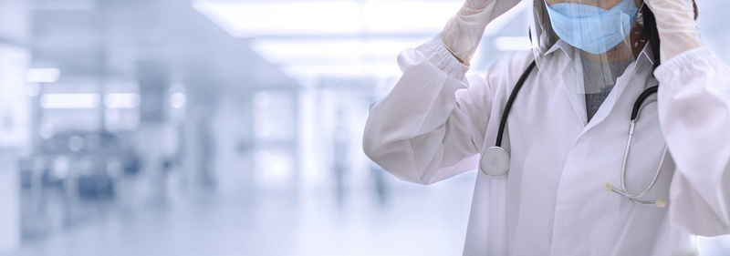 Midsection of person standing in corridor