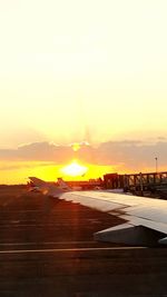 View of airport runway against sky during sunset