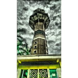 Low angle view of built structure against cloudy sky