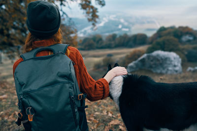 Rear view of woman on rock