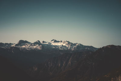 Scenic view of snowcapped mountains against clear sky