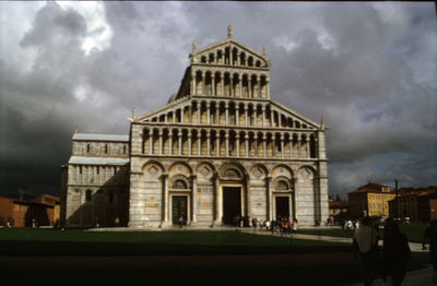 Facade of historic building against cloudy sky