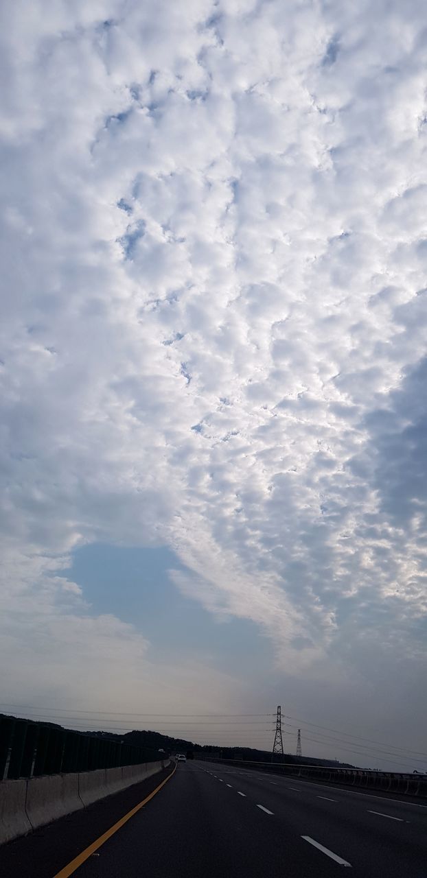 cloud - sky, road, sky, transportation, direction, the way forward, sign, symbol, nature, marking, road marking, no people, diminishing perspective, highway, beauty in nature, day, outdoors, mode of transportation, empty road, dividing line, long, crash barrier