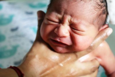 Close-up of crying baby boy at home