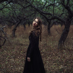 Portrait of mid adult woman standing in forest