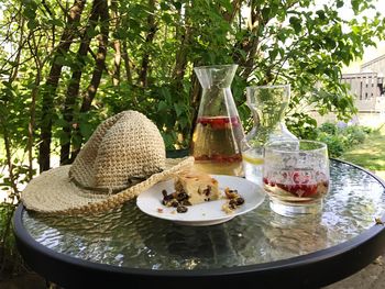 Wine bottles on table against trees