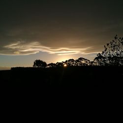 Silhouette landscape against sky at sunset