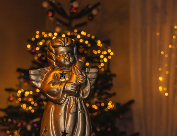 Close-up of statue against illuminated building