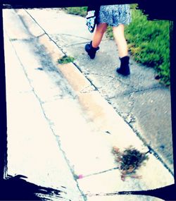 Low section of people walking on road