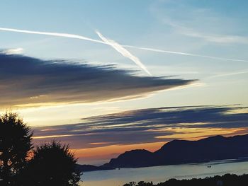 Scenic view of silhouette mountains against sky at sunset